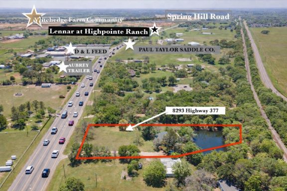 Aerial view of land with  Highway 377 road frontage, featuring a pond and surrounding trees.